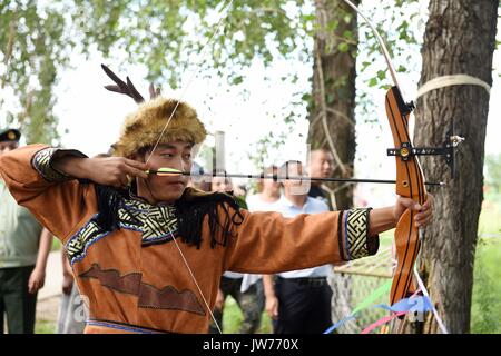 Xunke, China's Heilongjiang Province. 11th Aug, 2017. Oroqen athlete competes in a archery event during sports competition of the ethnic group's traditional God-of-fire sacrifice festival in Xunke County, northeast China's Heilongjiang Province, Aug. 11, 2017. The Gulunmuta Festival, the most important festival for the Oroqen people, was listed as one of the first batch of China's intangible cultural heritages in 2006. Credit: Wang Jianwei/Xinhua/Alamy Live News Stock Photo