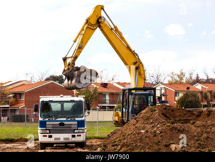 Loading soil for removal into tip truck Stock Photo