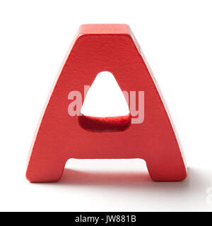 Red painted wooden letter A isolated on white background. Stock Photo