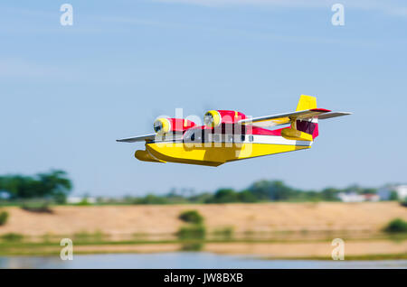 Radio controlled model hydroplane  flying on a nice cloudy day over Guadiana River in Badajoz, Extremadura, Spain Stock Photo