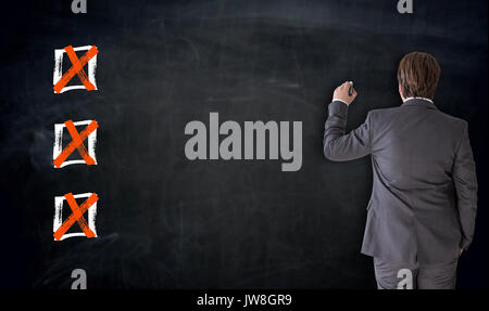 Businessman writing with checkbox concept on blackboard. Stock Photo