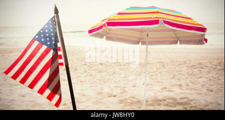 Flare against beach umbrella at tropical sand beach Stock Photo