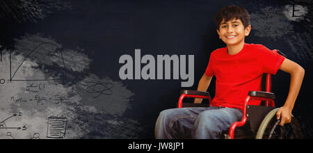 Portrait of boy sitting in wheelchair against black background Stock Photo