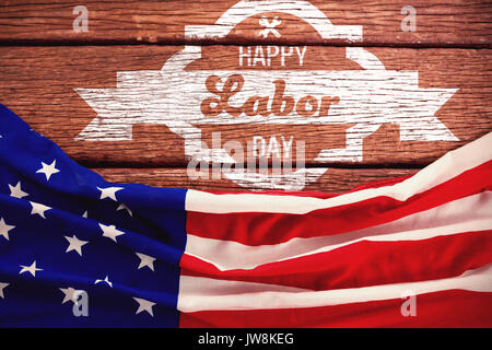 Digital composite image of happy labor day banner against american flag on a brown table Stock Photo