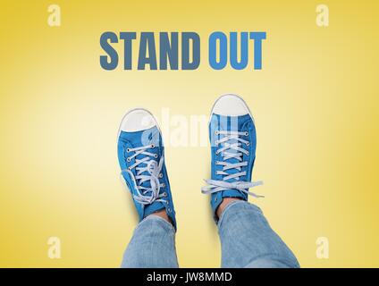 Digital composite of Stand out text and Blue shoes on feet with yellow background Stock Photo