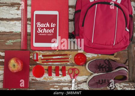 Digital composite of Tablet on a school table with back to school text on screen Stock Photo