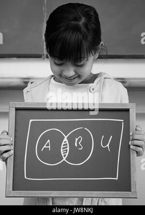 Digital composite of Girl holding blackboard with chart diagrams Stock Photo