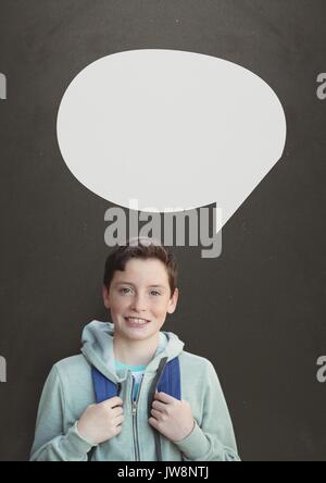 Digital composite of Student boy with speech bubble against grey background Stock Photo