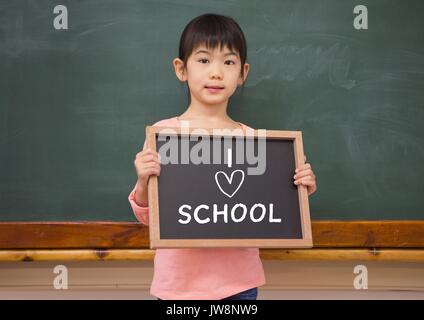 Digital composite of I love school text and little girl with blackboard Stock Photo