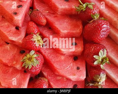 tile of sliced watermelons and strawberries Stock Photo