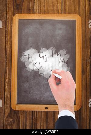 Digital composite of Hand writing letters on blackboard Stock Photo