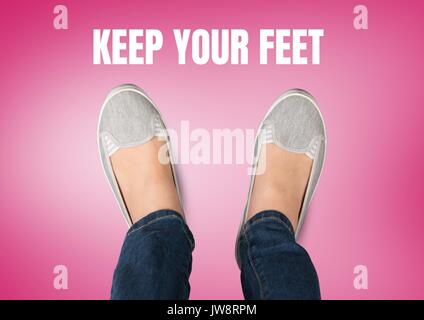 Digital composite of Keep your feet text and Grey shoes on feet with pink background Stock Photo