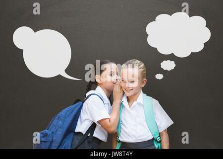 Digital composite of Student girls with speech bubbles whispering against grey background Stock Photo