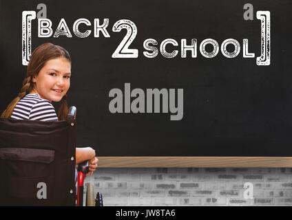 Digital composite of Back 2 school text on blackboard with with disabled girl in wheelchair Stock Photo