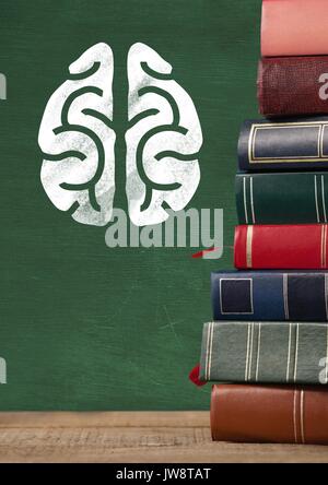 Digital composite of Books on Desk foreground with blackboard graphics of brain Stock Photo