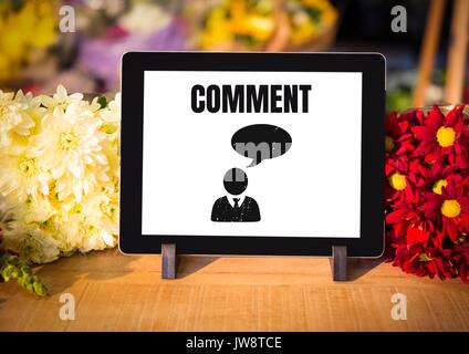 Digital composite of Comment text and chat graphic on tablet screen with flowers Stock Photo