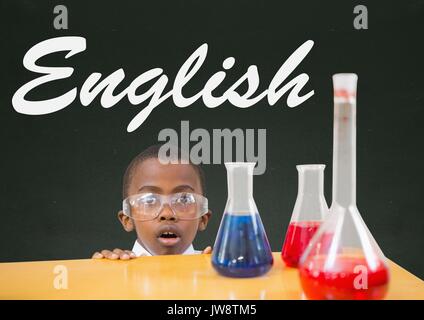 Digital composite of Surprised student boy at table against green blackboard with English text Stock Photo