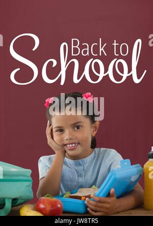 Digital composite of Happy student girl at table against red blackboard with back to school text Stock Photo