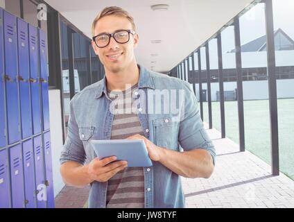 Digital composite of male student holding tablet in front of lockers Stock Photo