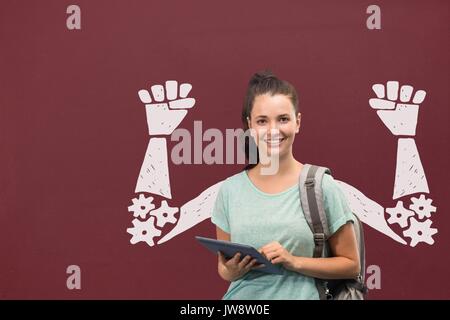 Digital composite of Happy student woman with fists graphic standing against red blackboard Stock Photo