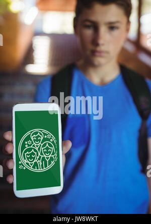 Digital composite of Boy holding a phone with school icons on screen Stock Photo