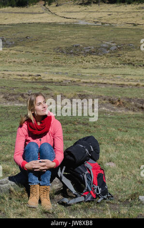 High angle view of thoughtful woman looking away while sitting on rock Stock Photo