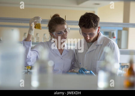 Young students practicing chemistry experiment in lab Stock Photo