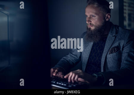 Businessman working at desk in office Stock Photo