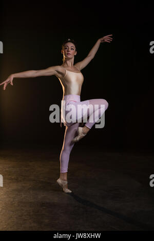 Graceful ballerina standing en pointe in the ballet studio Stock Photo