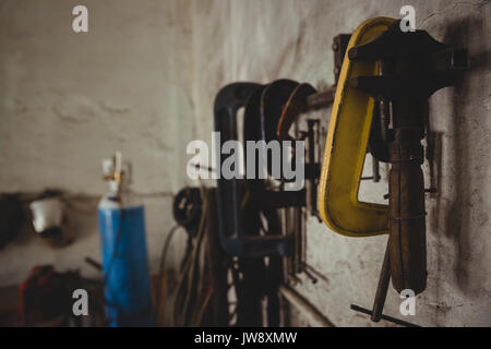 Tools hanging on wall in workshop Stock Photo