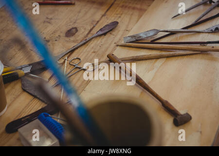 Various work tools on table in workshop Stock Photo