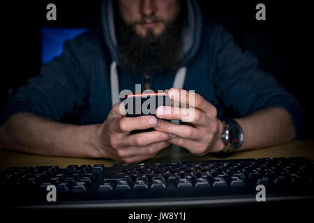 Executive using mobile phone at desk in office Stock Photo