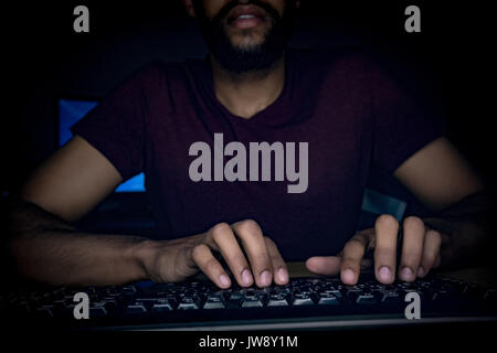 Mid section of executive typing on keyboard at desk in office Stock Photo