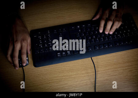 Overhead view of executive working at desk in office Stock Photo