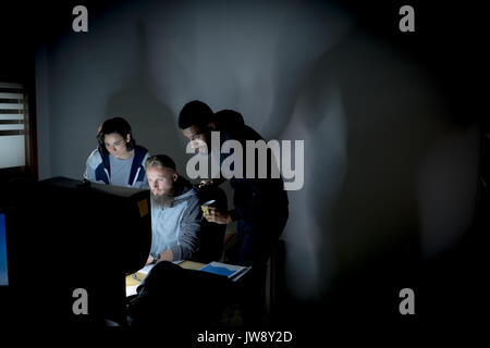 Colleagues working together at desk in office Stock Photo