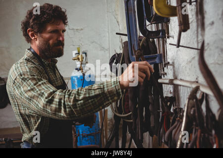 Attentive craftsman working in workshop Stock Photo