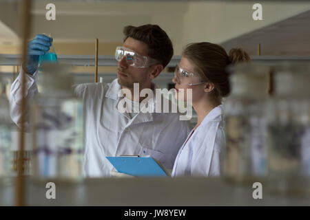 Young university students practicing chemistry experiment in lab Stock Photo