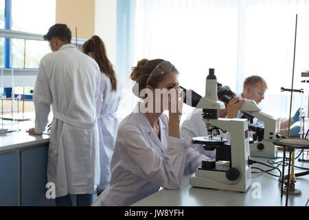 University students practicing science experiment in lab Stock Photo
