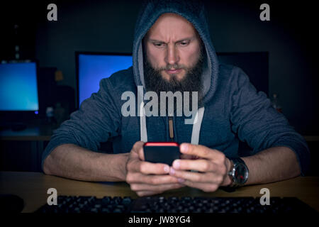 Executive using mobile phone at desk in office Stock Photo
