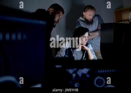 Colleagues working on personal computer at desk in office Stock Photo