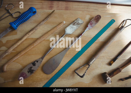 Various metal tools on wooden table in workshop Stock Photo