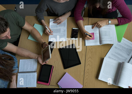 High angle view of university students studying at desk in classroom Stock Photo