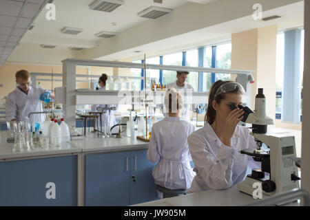 Students practicing experiment in lab Stock Photo