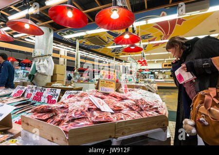 Low-angle view of pre-packed plastic shrink wrapped fish on fish-monger stall in Omicho famous fresh food indoor market in Kanazawa, Japan. Stock Photo