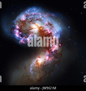 The Antennae Galaxies or NGC 4038 or NGC 4039 are undergoing a galactic collision. Located in the constellation Corvus. Retouched image. Elements of t Stock Photo
