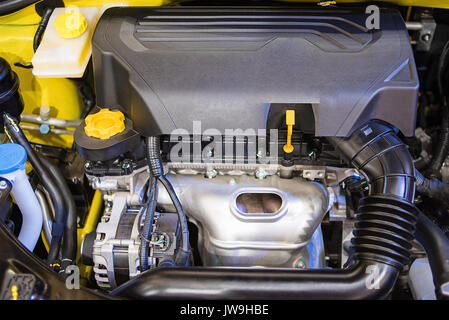 Closeup detail of new car and new engine in factory for the background. Stock Photo