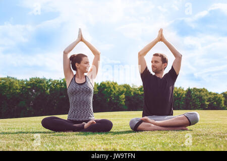Man and woman practice acro yoga in the park meditation Stock Photo