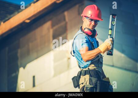 Construction Worker with Level Tool and the Construction Site. Stock Photo