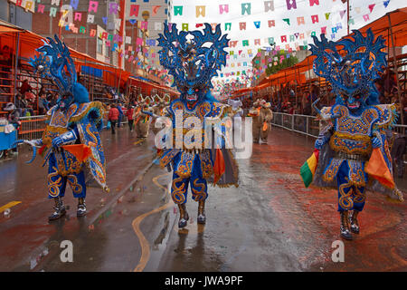 Masked Diablada dancers in ornate costumes parade through the mining city of Oruro on the Altiplano of Bolivia during the annual carnival. Stock Photo