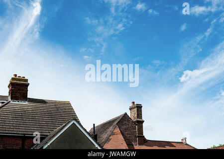 Tiled Village Roof Tops Under A Blue Summer Sky Stock Photo